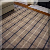 DR03. Tan and blue plaid rug. Meaures approx. 13' x 16'4” 